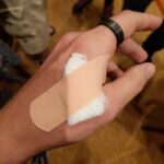 My hand, with a bandage covering the site of the NFC implant.